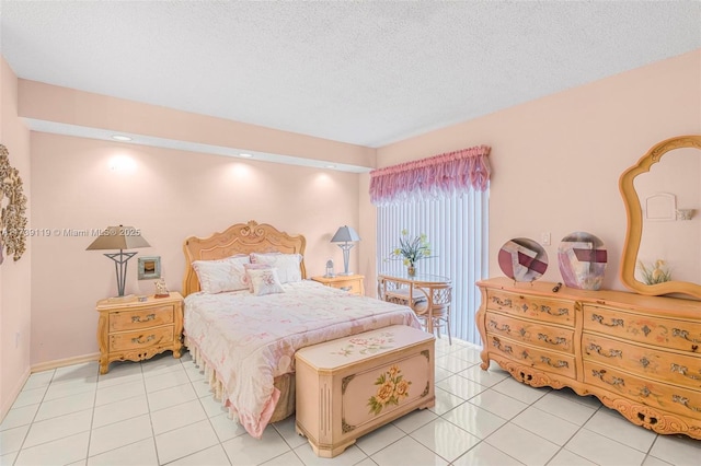 tiled bedroom featuring a textured ceiling