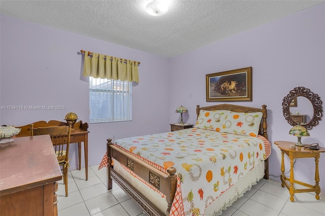 bedroom featuring light tile patterned flooring and a textured ceiling