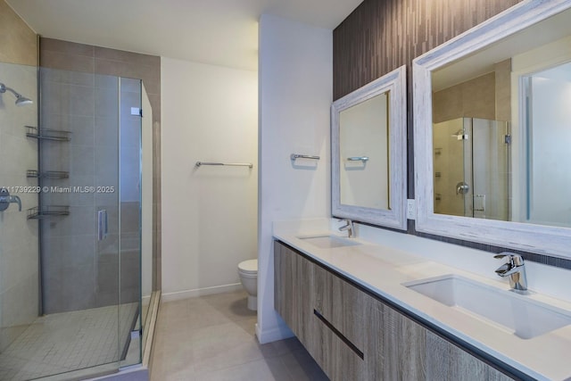 bathroom with vanity, toilet, and a shower with shower door