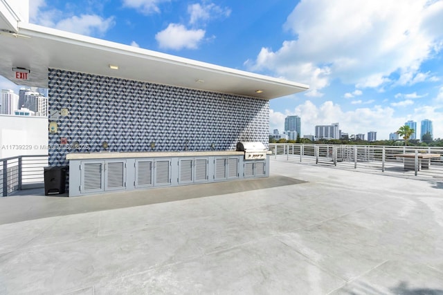 view of patio featuring a grill and an outdoor kitchen