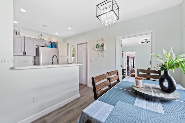 dining area featuring sink and dark hardwood / wood-style flooring