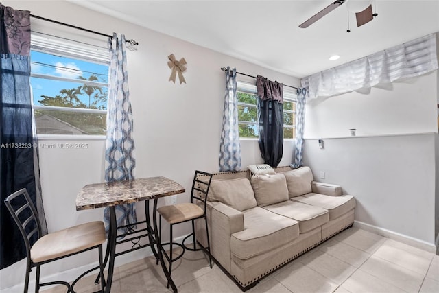 tiled living room with ceiling fan