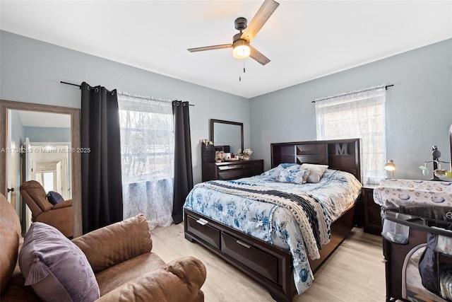 bedroom with ceiling fan and light wood-type flooring