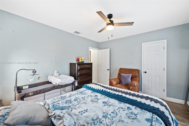 bedroom with wood-type flooring and ceiling fan