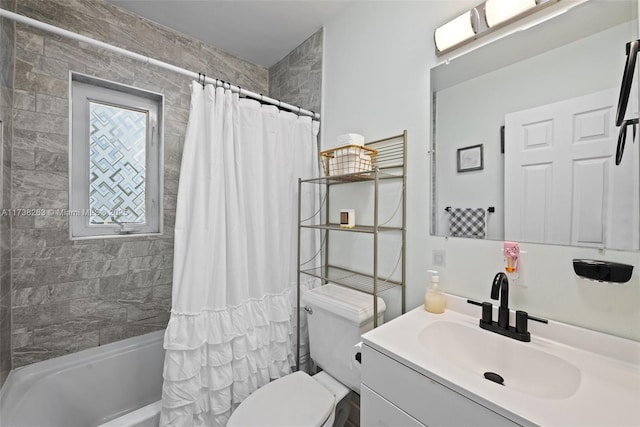 full bathroom with vanity, shower / tub combo with curtain, and toilet