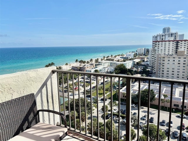 balcony with a water view and a beach view