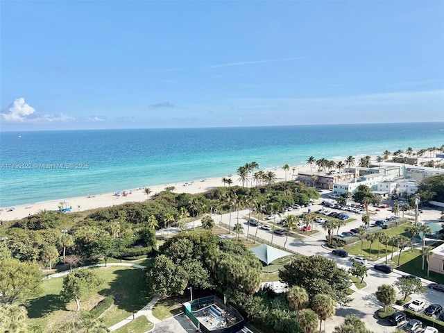 drone / aerial view with a water view and a beach view