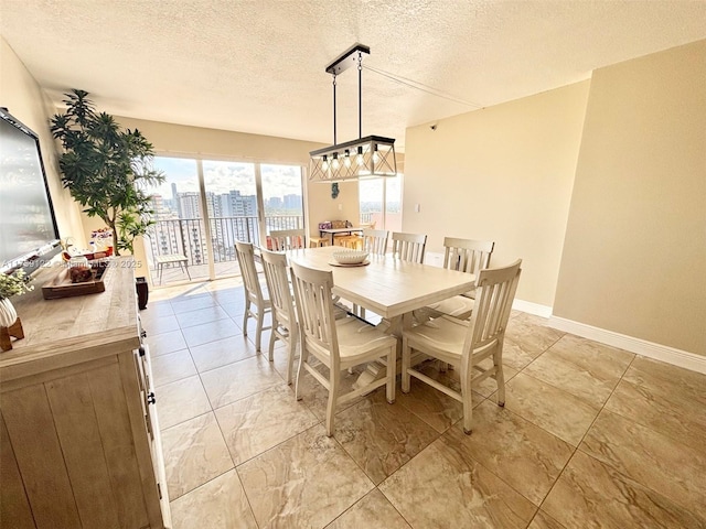 dining space featuring a textured ceiling