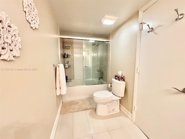 bathroom with combined bath / shower with glass door, tile patterned floors, and toilet