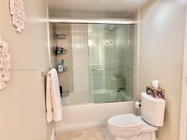 bathroom with enclosed tub / shower combo, tile patterned floors, and toilet