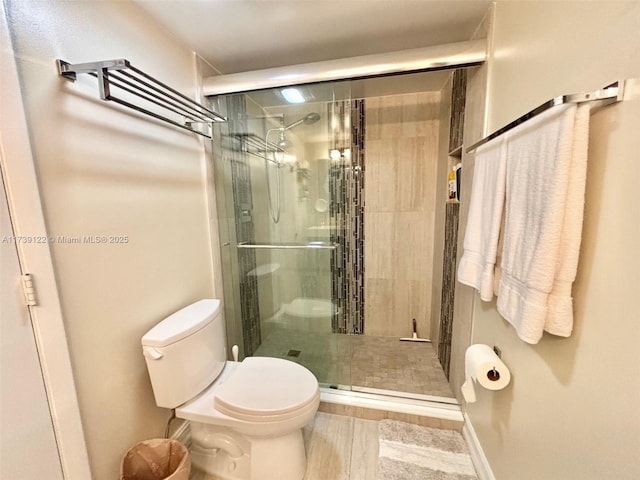 bathroom featuring toilet and walk in shower