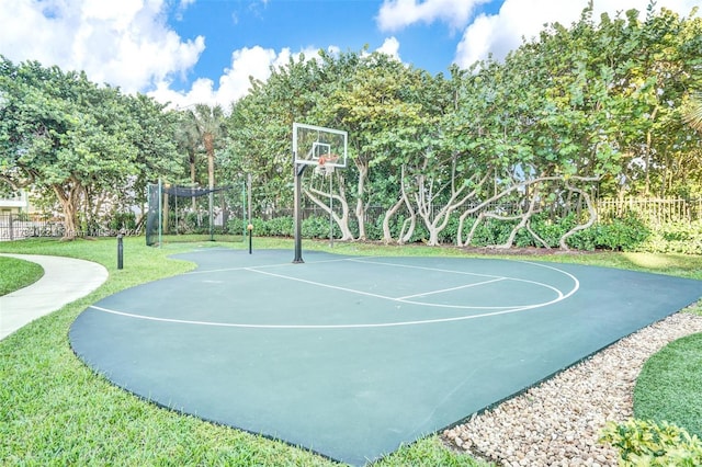 view of basketball court with a lawn