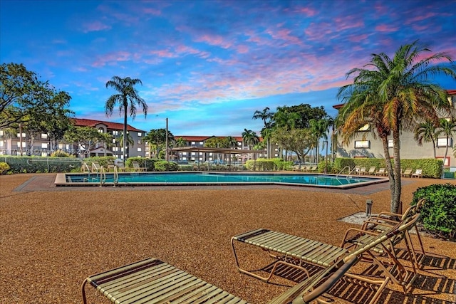 view of pool at dusk