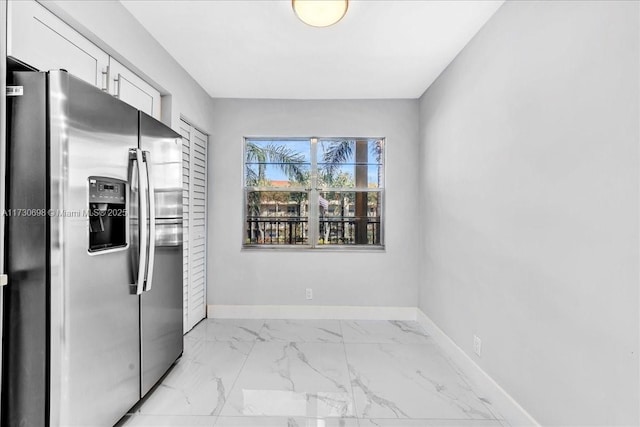 kitchen featuring stainless steel fridge with ice dispenser and white cabinets