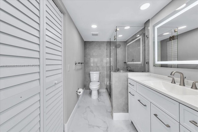 bathroom with vanity, toilet, and a shower with shower door