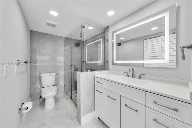 bathroom featuring vanity, a shower with shower door, tile walls, and toilet