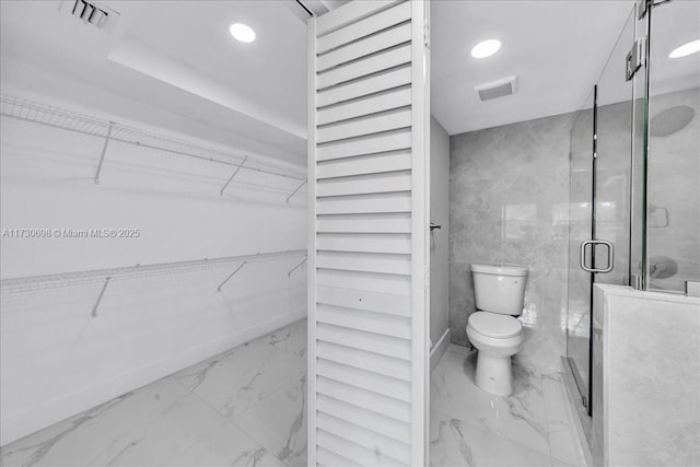 bathroom with toilet and walk in shower