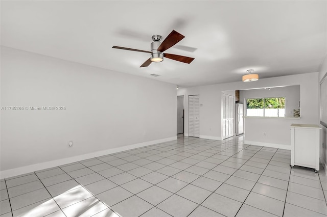 unfurnished room featuring light tile patterned flooring and ceiling fan