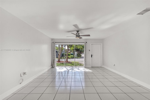 empty room with light tile patterned floors and ceiling fan