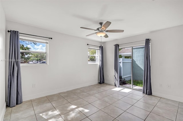 tiled empty room featuring ceiling fan