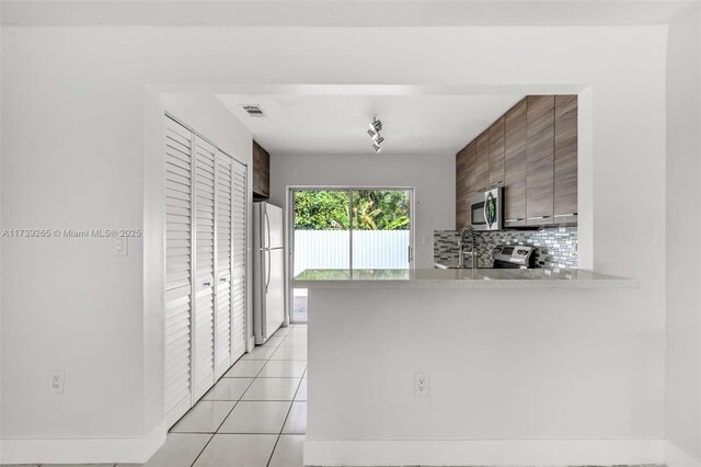 unfurnished bedroom with access to outside, a closet, ceiling fan, and light tile patterned flooring