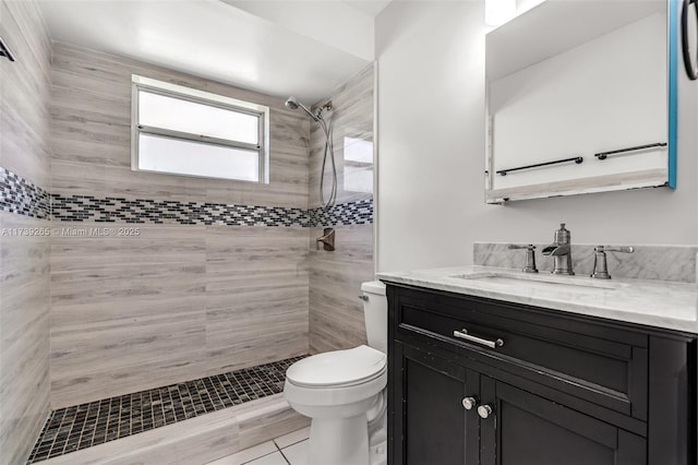 bathroom featuring vanity, toilet, and a tile shower