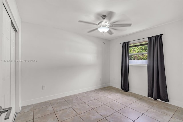 unfurnished room featuring ceiling fan and light tile patterned floors