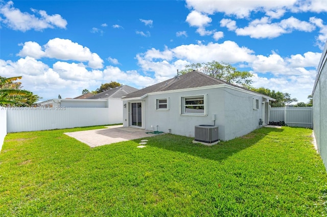 back of property featuring a yard, a patio area, and central air condition unit