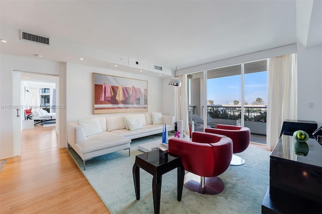 living room with a wealth of natural light and hardwood / wood-style floors