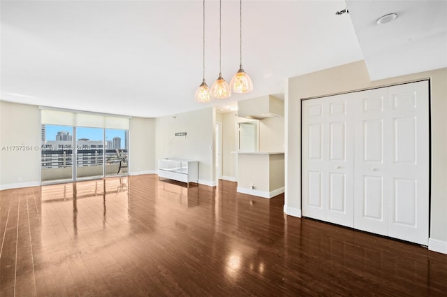 unfurnished living room featuring hardwood / wood-style flooring and a wall of windows