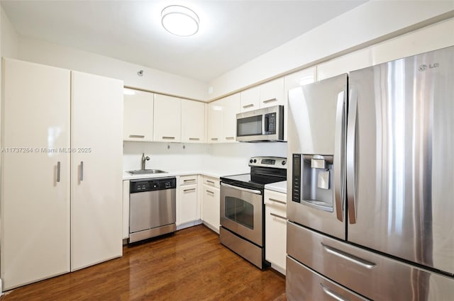 kitchen featuring white cabinetry, sink, dark wood-type flooring, and stainless steel appliances