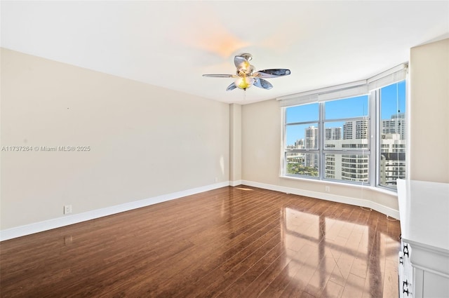 unfurnished room with hardwood / wood-style floors and ceiling fan