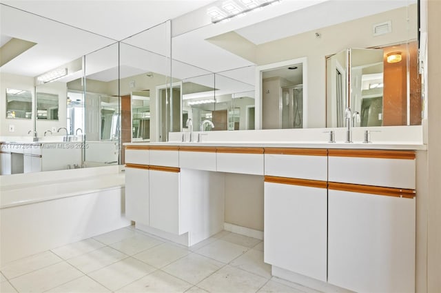 bathroom with tile patterned floors, vanity, and shower with separate bathtub