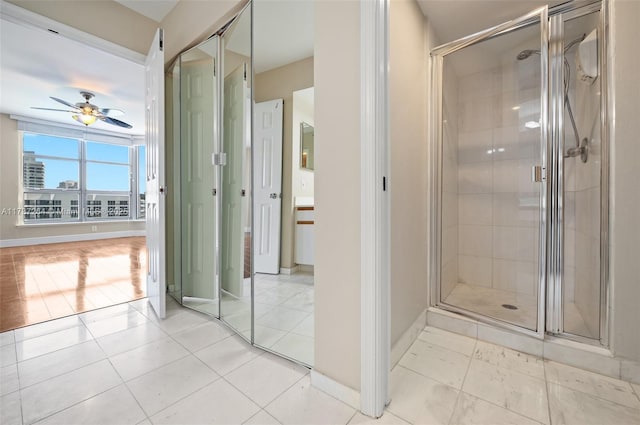 bathroom featuring tile patterned flooring, a shower with door, and ceiling fan