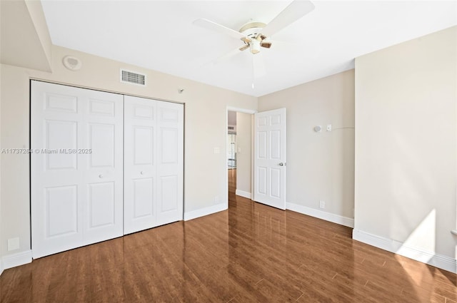 unfurnished bedroom with hardwood / wood-style flooring, ceiling fan, and a closet