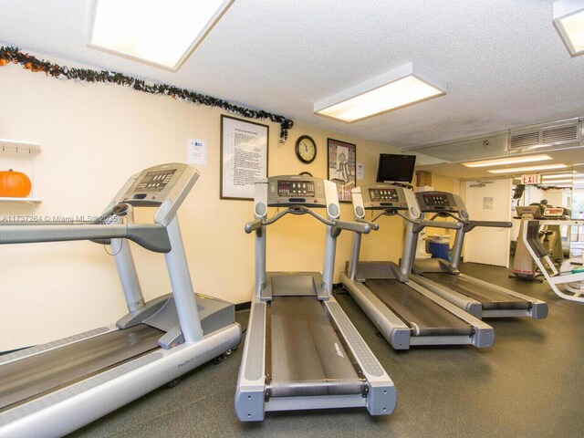 gym with a textured ceiling