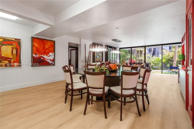 101 Ocean Lane Dr Unit 1017, Key Biscayne, FL 33149 - dining space featuring light wood-style floors, baseboards, and a wall of windows