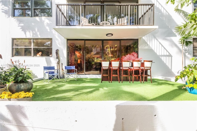 101 Ocean Lane Dr Unit 1017, Key Biscayne, FL 33149 - back of house with a balcony, stucco siding, a patio area, and a yard