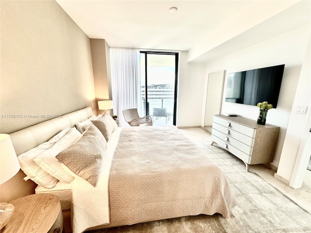 bedroom with expansive windows, baseboards, light carpet, and access to exterior