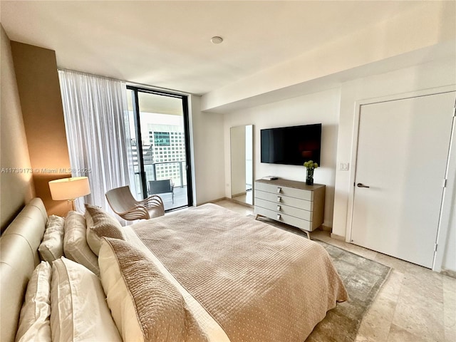 bedroom with access to outside and expansive windows