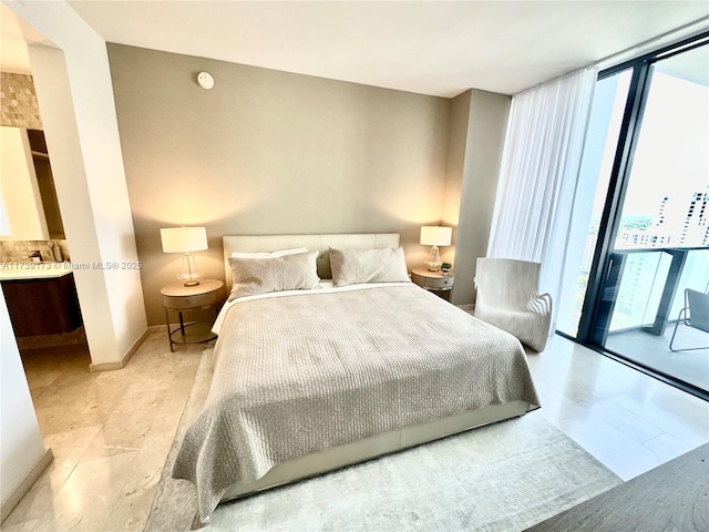 bedroom featuring floor to ceiling windows and baseboards