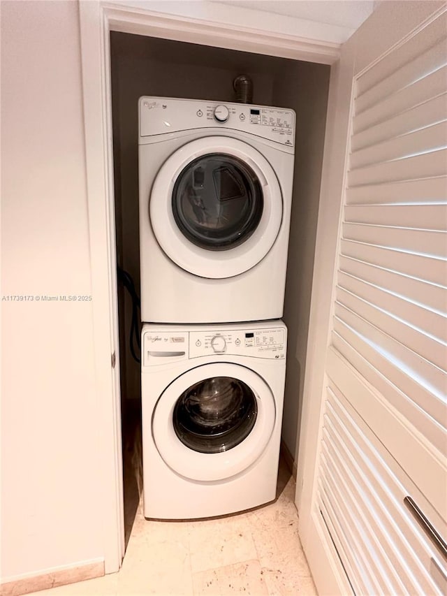 washroom with stacked washer / dryer and laundry area