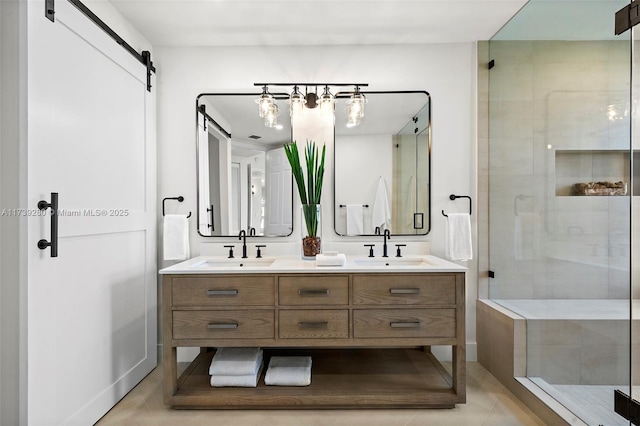 bathroom with tile patterned floors, vanity, and an enclosed shower