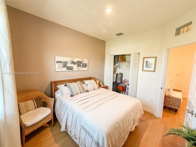 bedroom featuring a closet and light hardwood / wood-style flooring