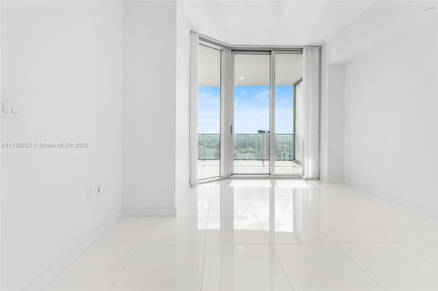 tiled spare room with expansive windows