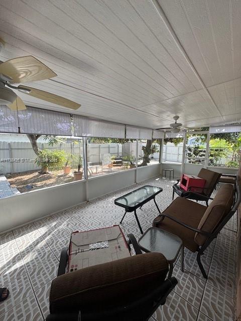 sunroom featuring ceiling fan