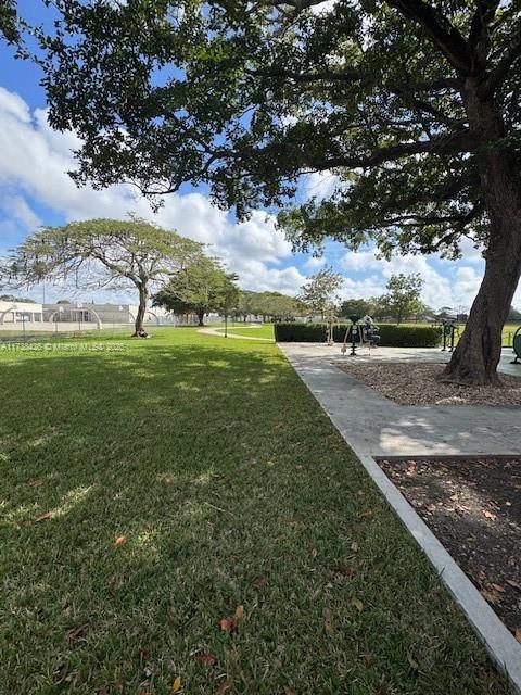 view of property's community with a lawn