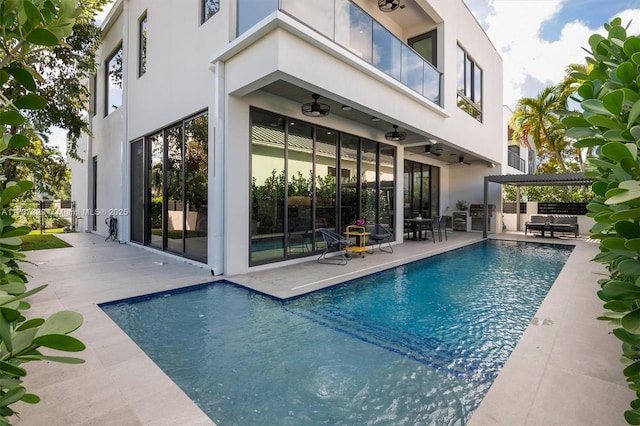 view of pool with a patio, ceiling fan, and a pergola