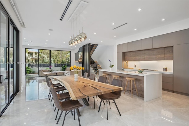 dining room with sink and a wall of windows