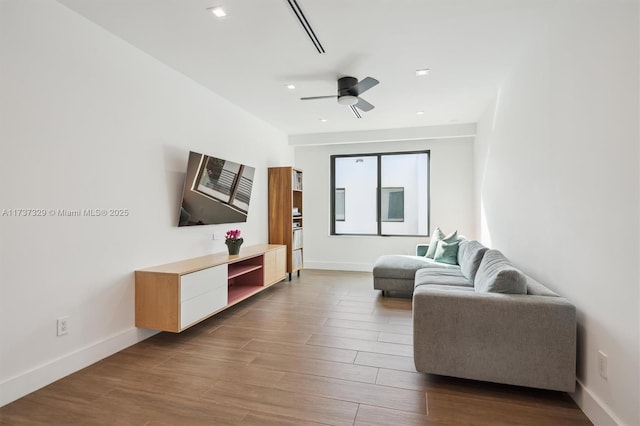 living room with wood-type flooring and ceiling fan